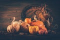 Autumn still life with pumpkins and candles on wooden background. Thanksgiving home decoration Royalty Free Stock Photo