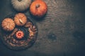 Autumn still life with pumpkins and candles on wooden background. Thanksgiving home decoration Royalty Free Stock Photo