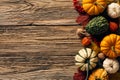 Autumn still life with pumpkins, fallen leaves, walnuts, fall decorations on wooden background. Happy Thanksgiving Day concept. Royalty Free Stock Photo
