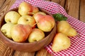 Autumn still life. Ripe pears on wooden table with red checkered tablecloth. Rustic design Royalty Free Stock Photo