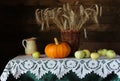 Autumn still life, rye spikelets in a wicker basket, pumpkin and apples