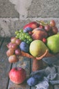 Autumn still life for thanksgiving with autumn fruits and berries on wooden background - grapes, apples, plums, viburnum, dogwood Royalty Free Stock Photo