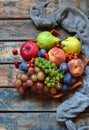 Autumn still life for thanksgiving with autumn fruits and berries on wooden background - grapes, apples, plums, viburnum, dogwood Royalty Free Stock Photo