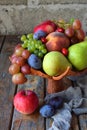 Autumn still life for thanksgiving with autumn fruits and berries on wooden background - grapes, apples, plums, viburnum, dogwood. Royalty Free Stock Photo