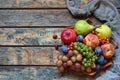 Autumn still life for thanksgiving with autumn fruits and berries on wooden background - grapes, apples, plums, viburnum, dogwood. Royalty Free Stock Photo