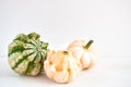 Autumn still life with three decorative pumpkins on a white background. Copy space for text.Template for your design, invitation,