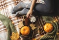 Autumn still life from tray full of pumpkin, leaves, cones, scarf, mug of cocoa, coffee or hot chocolate with