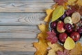 Autumn still life with various fruits are lying in a wicker basket. Autumn maple and poplar leaves. Royalty Free Stock Photo