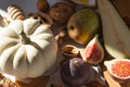 Autumn still-life with white pumpkin, sliced figs, walnuts and pears on wooden cutting board. Healthy eating concept. Royalty Free Stock Photo