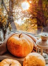 Autumn still life on the windowsill, pumpkins and a lighted lantern with candles, outside the window golden October, Halloween Royalty Free Stock Photo