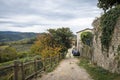 Autumn street with stone wall, wooden fence and views of the Tuscan valley in Panzano in Chianti, Tuscany, Italy Royalty Free Stock Photo