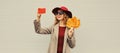 Autumn style outfit, stylish elegant happy woman posing taking selfie with mobile phone holds yellow maple leaves wearing hat, Royalty Free Stock Photo