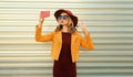 Autumn style outfit, stylish elegant woman posing taking selfie with mobile phone wearing hat, orange jacket and sunglasses on Royalty Free Stock Photo