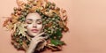 Autumn style Woman make-up. Beautiful fashion art model girl portrait with bright autumnal yellow, orange color leaves, oak acorns Royalty Free Stock Photo