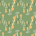 Autumn stylized seamless pattern with mushrooms. Green background with orange nature wild fungus elements