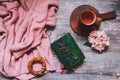 Autumn or summer garden table top view with cozy sweater, coffee, glasses, sketch book, dried hydrangea flowers