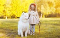 Autumn sunny photo child and dog walking in the park