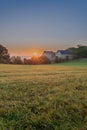 An autumn sunrise in Maastricht overlooking the meadows of the Sint Pieter hill with an historical farm Hoeve Zonneberg Royalty Free Stock Photo