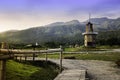 Autumn sunrise in mountain rural area. Bamboo Walkway on nature with wind turbines in weathered  blue sky in morning light Royalty Free Stock Photo