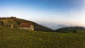 Autumn sunset at hillsides and meadow with mist over Danube river