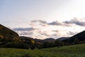 Autumn sunset orange green vibrant landscape rural power lines clouds blue sky hillside forest trees beautiful bulgaria Royalty Free Stock Photo