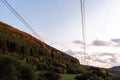 Autumn sunset orange green vibrant landscape rural power lines clouds blue sky hillside forest trees beautiful bulgaria Royalty Free Stock Photo