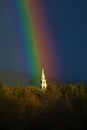 A rainbow lands on a church steeple Royalty Free Stock Photo