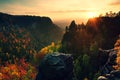 Autumn sunset in rocks. View over sandstone rocks to fall colorful valley of Bohemian Switzerland. Royalty Free Stock Photo