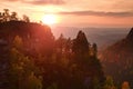 Autumn sunset in rocks. View over sandstone rocks to fall colorful valley of Bohemian Switzerland. Royalty Free Stock Photo