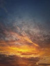 Autumn sunset sky. Vertical background, different colored and shaped clouds and flocks of migratory birds flying. October