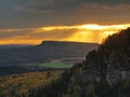 Autumn sunset view over sandstone rocks to fall colorful valley of Bohemian Switzerland. Sandstone peaks in forest. Royalty Free Stock Photo