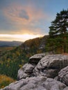 Autumn sunset view over sandstone rocks to fall colorful valley of Bohemian Switzerland. Sandstone peaks in forest. Royalty Free Stock Photo