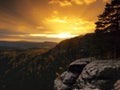 Autumn sunset view over sandstone rocks to fall colorful valley of Bohemian Switzerland. Sandstone peaks in forest. Royalty Free Stock Photo