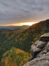 Autumn sunset view over sandstone rocks to fall colorful valley of Bohemian Switzerland. Sandstone peaks in forest. Royalty Free Stock Photo