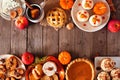 Autumn table scene double border of pies, appetizers and desserts. Top view over a wood background with copy space. Royalty Free Stock Photo