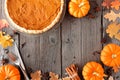 Autumn table scene frame with pumpkin pie over wood Royalty Free Stock Photo