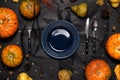 Autumn table setting with empty white plate and pumpkins. Royalty Free Stock Photo