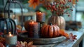 Autumn table setting with pumpkins, candles, and red berries Royalty Free Stock Photo