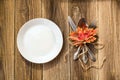 Thanksgiving dinner plate with fork, knife and autumn leaves on rustic wooden table background. Top view, copy space Royalty Free Stock Photo