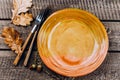 Autumn Table setting. Thanksgiving dinner plate with fork, knife and leaves on wooden background Royalty Free Stock Photo