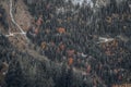 Autumn Tapestry: Aerial View of Mountain Forest with Winding Roads and Vibrant Colors