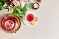 Autumn tea time with cup of tea, glass teapot and macaroons. Herbal raspberry natural tea. Aesthetic home with candle Royalty Free Stock Photo