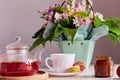 Autumn tea time - cup of tea with macarons, glass teapot, candle. Herbal raspberry natural tea. Cozy home with bouquet Royalty Free Stock Photo