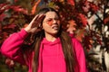 Autumn teen girl confused during fall season in park outdoor