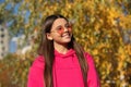 Autumn teen girl wearing in sunglasses and looks stylish. Fall season. Girl dreams in autumn fall. Autumn mood of