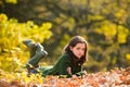 Autumn teenage on leafs. Teenager girl on autumn maple leaves at fall outdoors. Portrait of a beautiful teen. Royalty Free Stock Photo