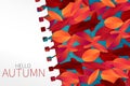 Autumn template with red and orange leaves on a blue background with a torn out sheet of note pad paper. Royalty Free Stock Photo