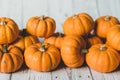 Autumn thanksgiving background. Leaves, pumpkins on wooden background.