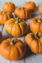 Autumn thanksgiving background. Leaves, pumpkins on wooden background.