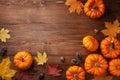 Autumn Thanksgiving background. Pumpkins, acorns and leaves on wooden board top view